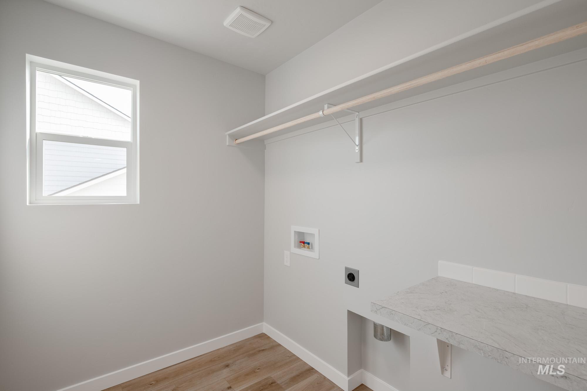 3304 West Morere Drive Meridian, ID 83642 - Photo 27 of 28 Washroom featuring light wood-style flooring, hookup for an electric dryer, and washer hookup