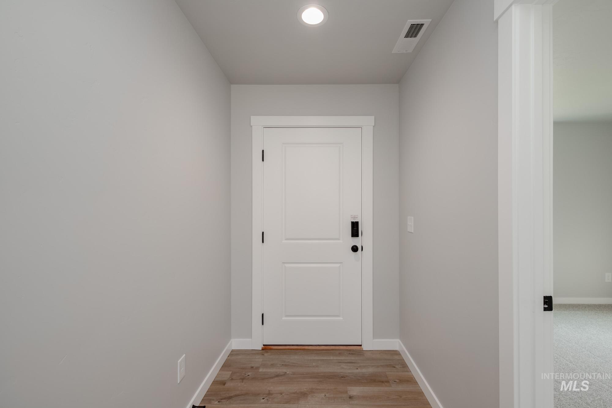 3304 West Morere Drive Meridian, ID 83642 - Photo 3 of 28 Doorway to outside with wood finished floors and recessed lighting