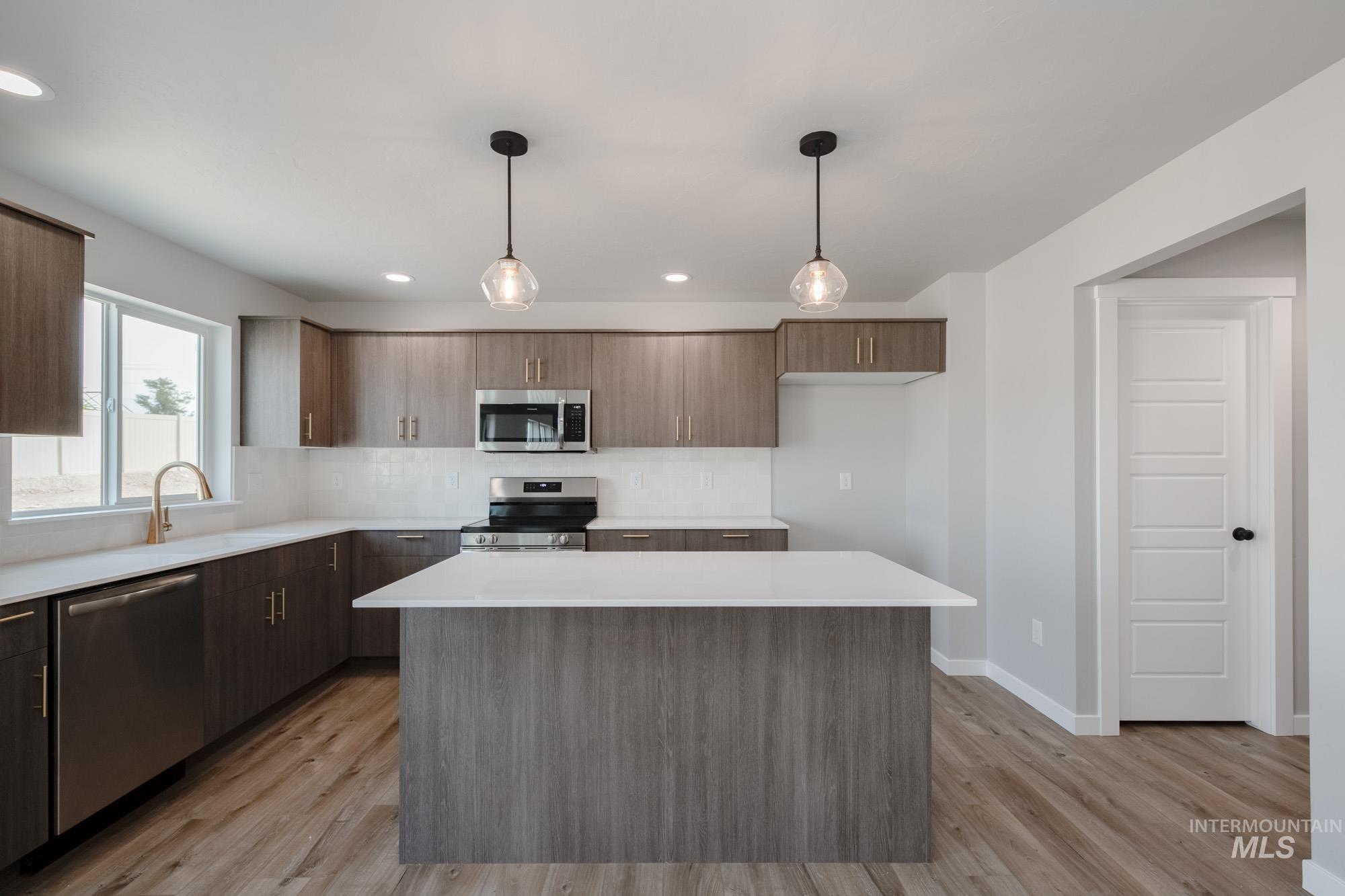 3304 West Morere Drive Meridian, ID 83642 - Photo 5 of 28 Kitchen with pendant lighting, stainless steel appliances, decorative backsplash, modern cabinets, and recessed lighting