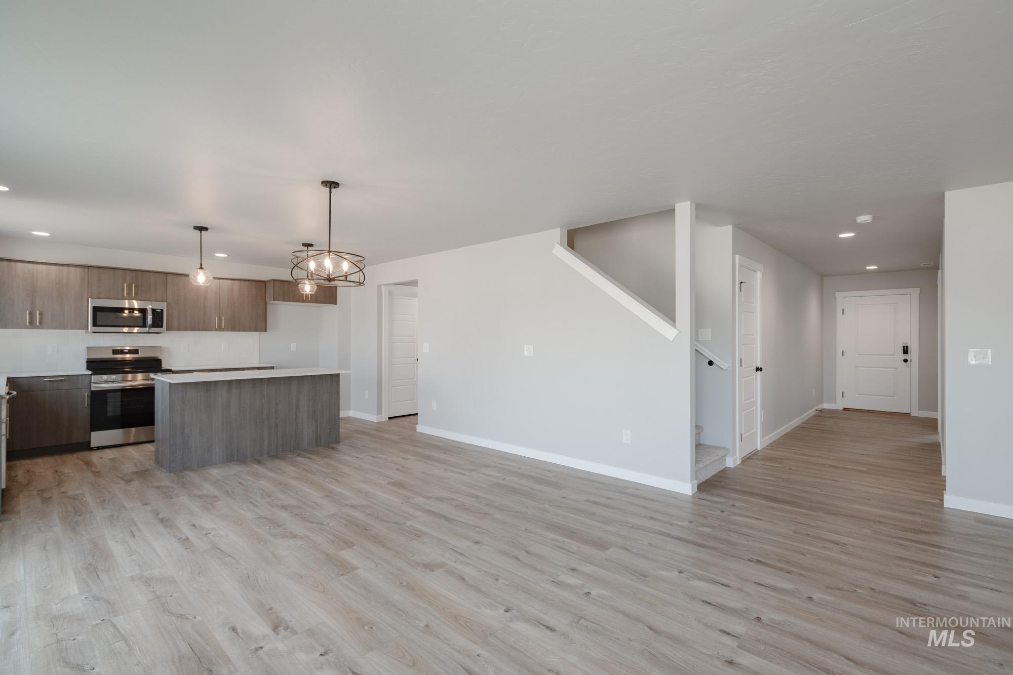 3304 West Morere Drive Meridian, ID 83642 - Photo 28 of 28 Kitchen with recessed lighting, open floor plan, a kitchen island, stainless steel appliances, and light countertops
