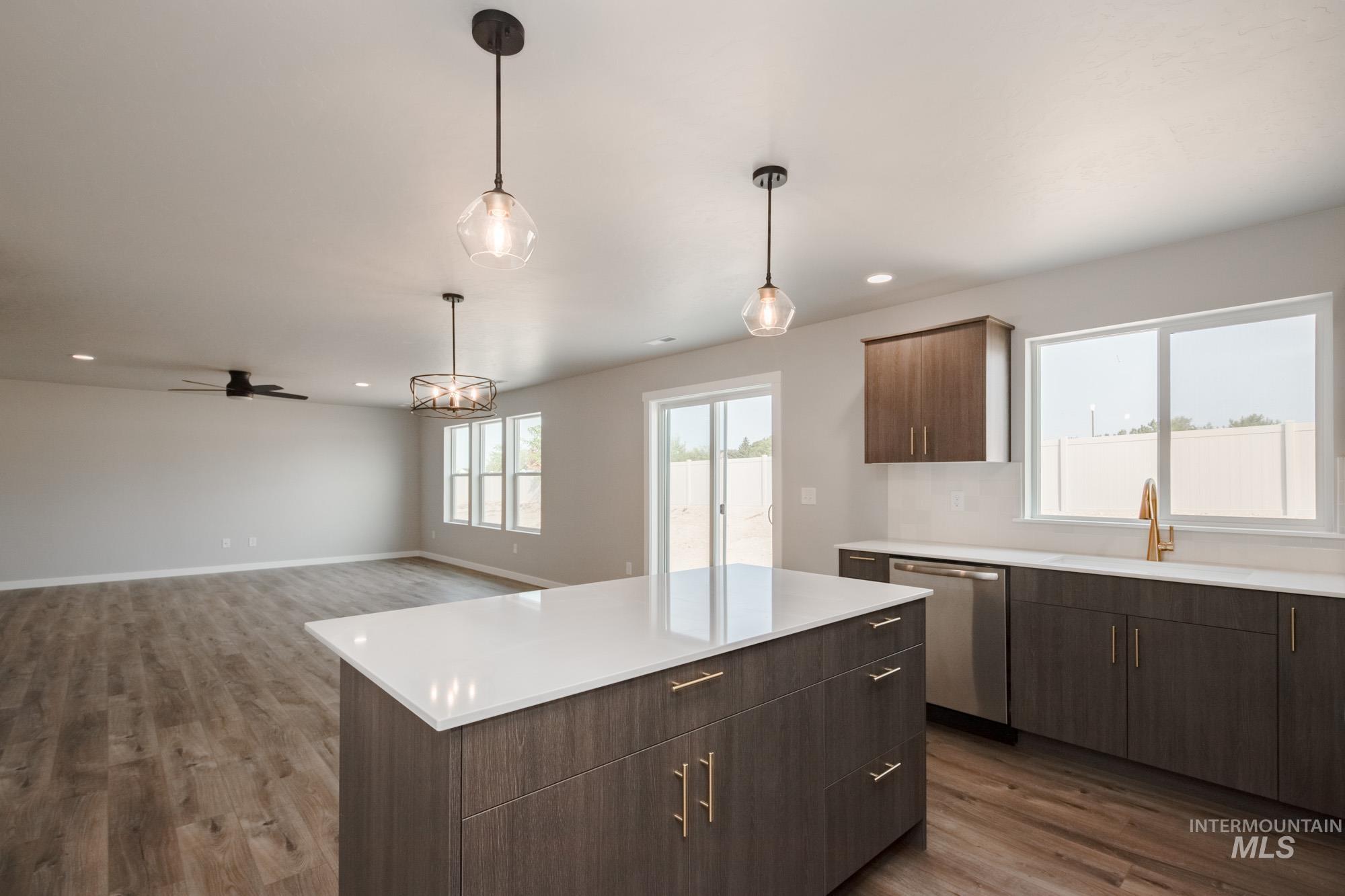 3304 West Morere Drive Meridian, ID 83642 - Photo 8 of 28 Kitchen featuring a center island, dark wood-style floors, dark brown cabinetry, decorative light fixtures, and recessed lighting