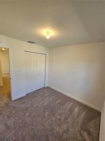 an empty room with an entrance to other room