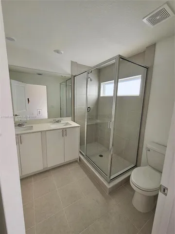 a bathroom with a shower a toilet and sink