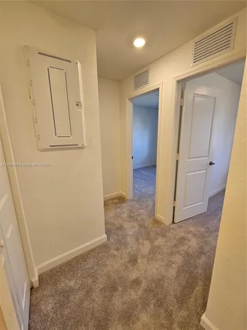an empty room with closet and mirror