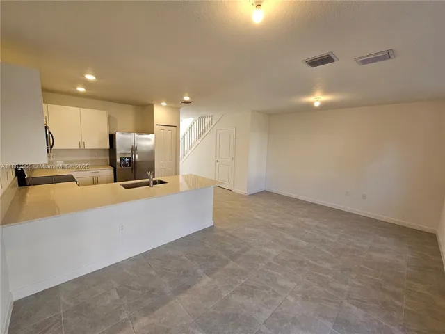 a large kitchen with a large window