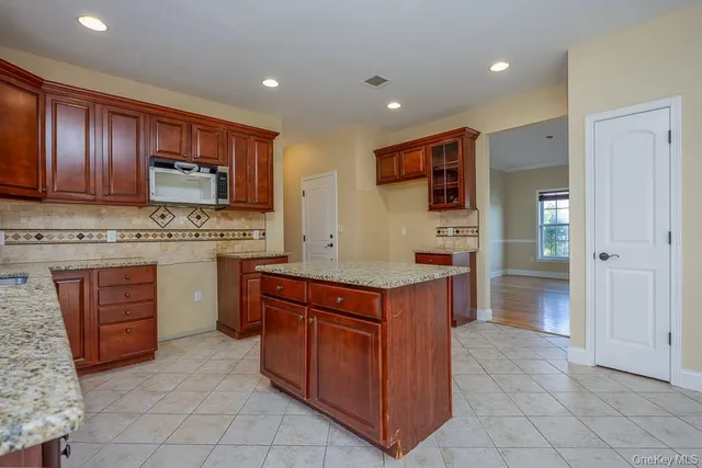 a kitchen with stainless steel appliances granite countertop a stove and a refrigerator