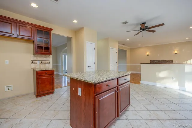 an open kitchen with granite countertop a stove and a sink