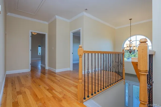 a view of a hallway view with wooden floor and staircase