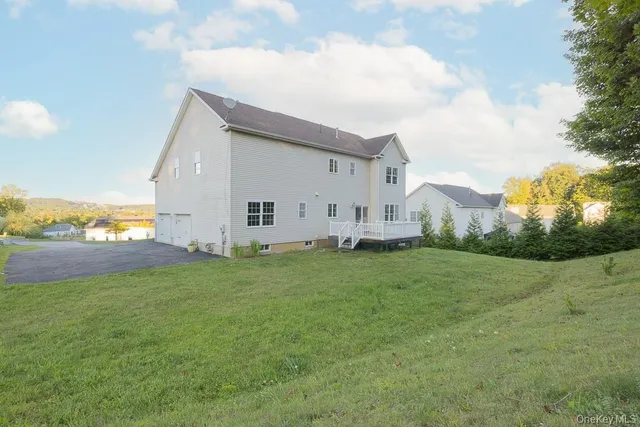 a view of a backyard with plants and large trees