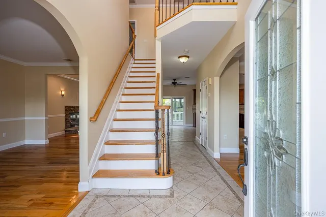a view of a hallway with wooden floor and entryway