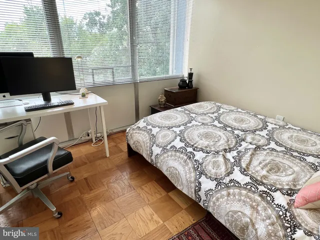 a bedroom with a bed and large window