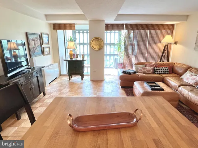 a living room with furniture fireplace and wooden floor
