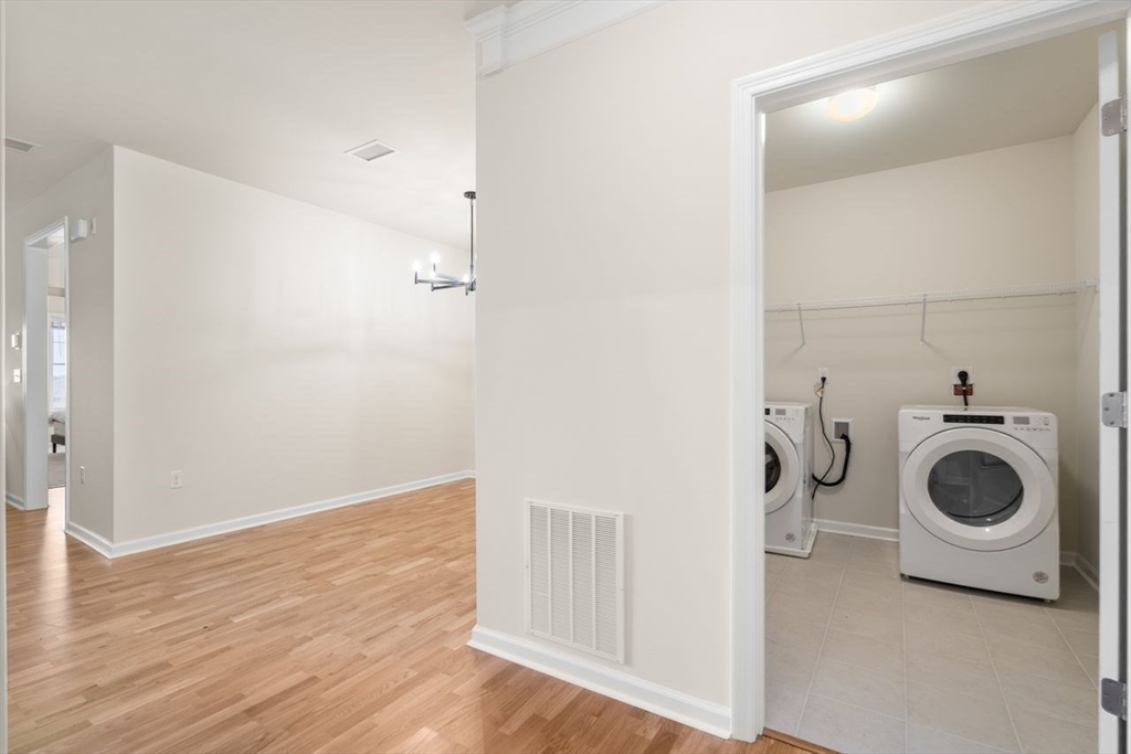 4 Stratton Drive, Unit 308 Woburn, MA 01801 - Photo 15 of 24 a view of a storage and utility room with wooden floor