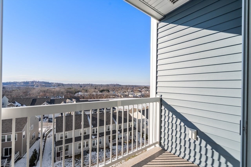 4 Stratton Drive, Unit 308 Woburn, MA 01801 - Photo 20 of 24 a view of a balcony with wooden fence