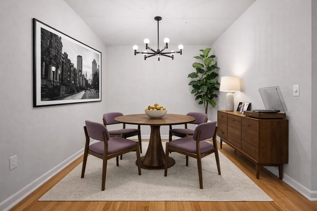 4 Stratton Drive, Unit 308 Woburn, MA 01801 - Photo 5 of 24 a view of a dining room with furniture wooden floor and a chandelier
