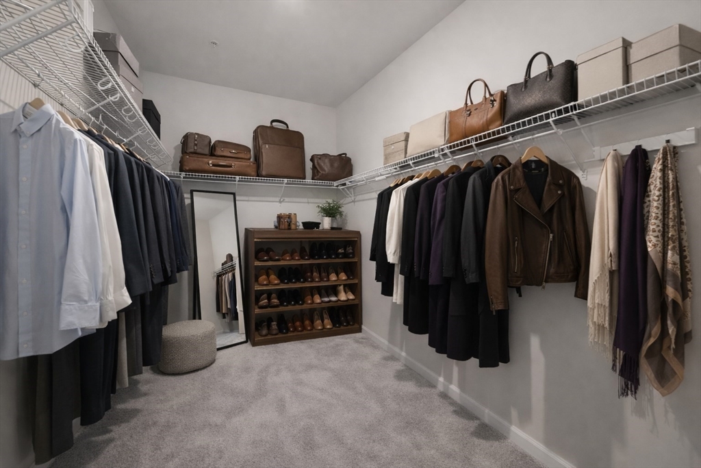 4 Stratton Drive, Unit 308 Woburn, MA 01801 - Photo 9 of 24 a view of walk in closet with clothes and shoes