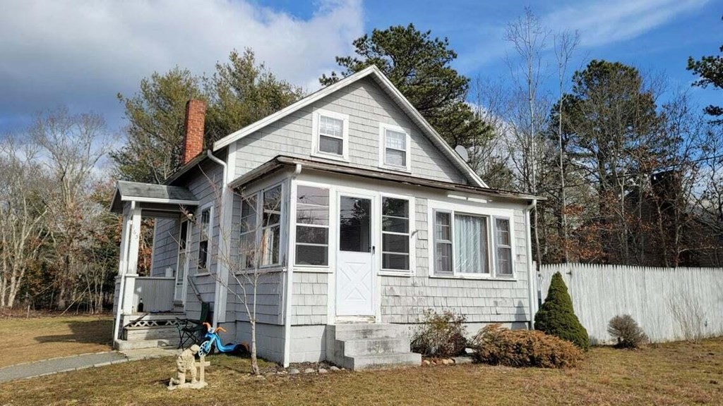 163 Hayway Road East Falmouth, MA 02536 - Photo 1 of 9 a view of a white house with large windows next to a road