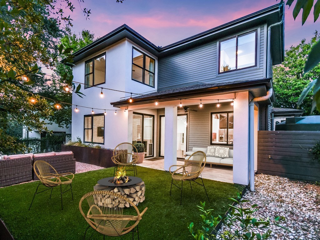 a front view of a house with fountain table and chairs