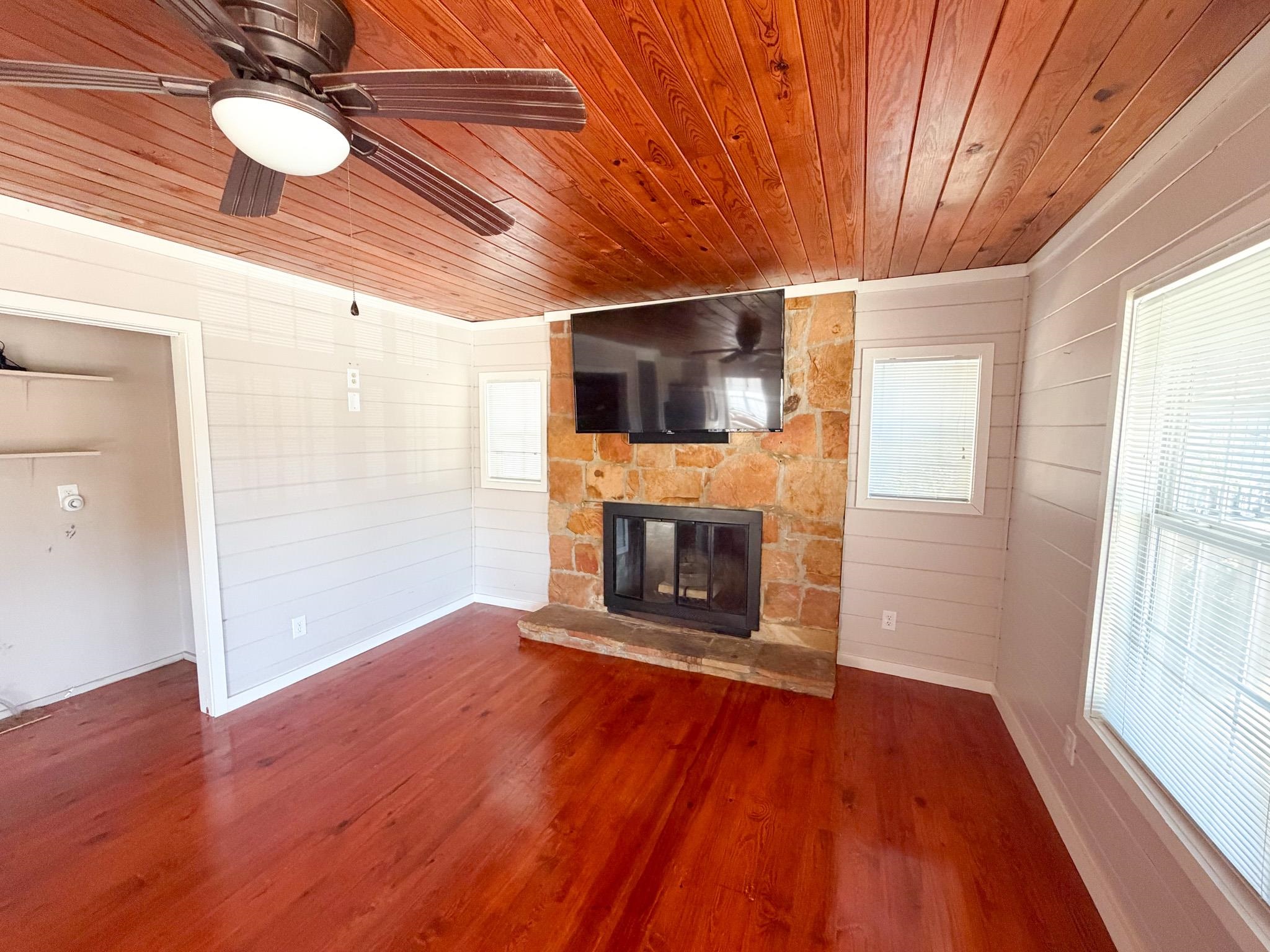 905 Cr 956 Road Iuka, MS 38852 - Photo 6 of 16 a view of a livingroom with a fireplace a ceiling fan and wooden floor