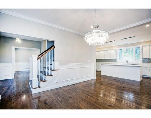 10 Old Cart Path Norfolk, MA 02056 - Photo 4 of 23 a view of an empty room and kitchen with wooden floor