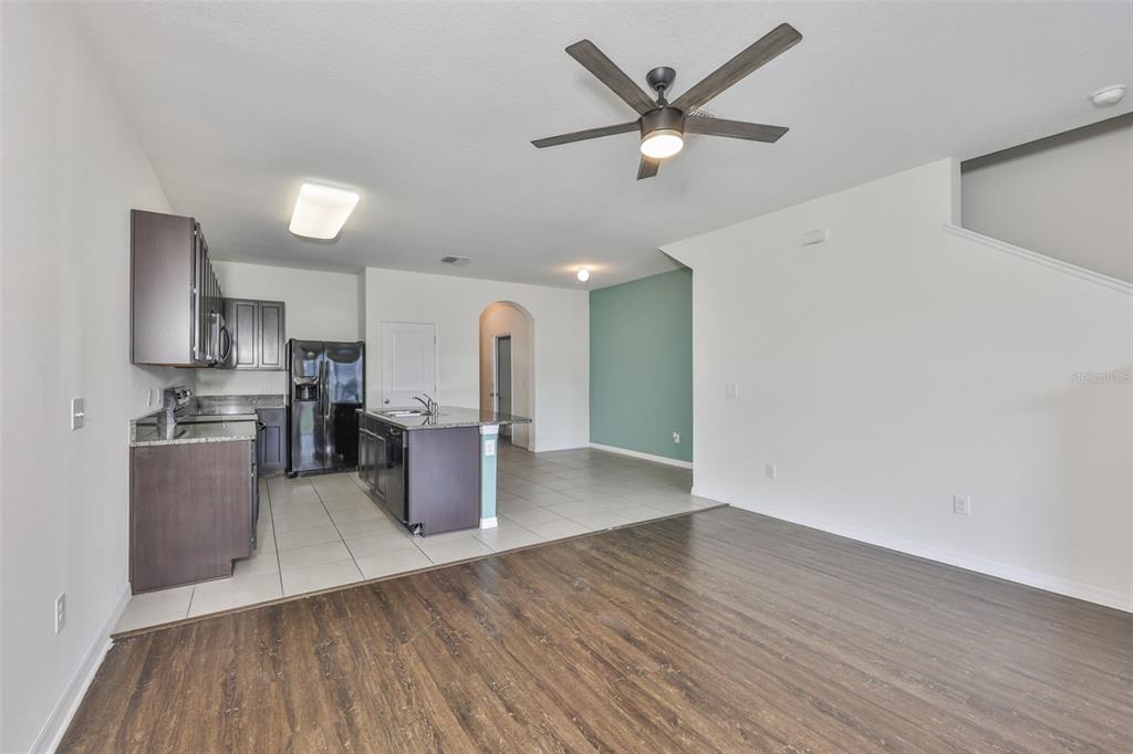 8969 Indigo Trail Loop Riverview, FL 33578 - Photo 11 of 41 a kitchen with stainless steel appliances a refrigerator a sink dishwasher a stove and white countertops with wooden floor