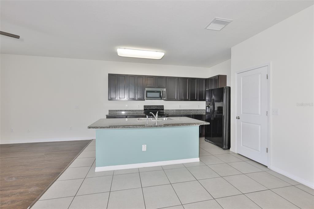 8969 Indigo Trail Loop Riverview, FL 33578 - Photo 16 of 41 a large white kitchen with a sink and dishwasher