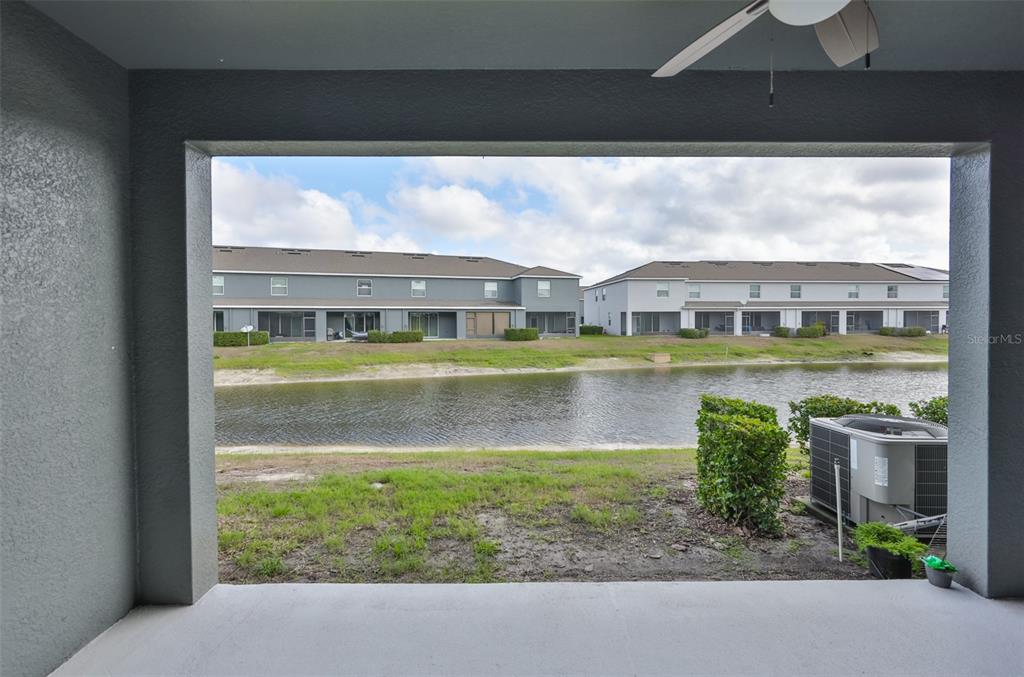 8969 Indigo Trail Loop Riverview, FL 33578 - Photo 20 of 41 a view of a lake with a building in the background