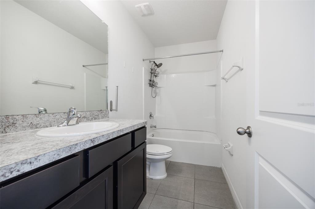 8969 Indigo Trail Loop Riverview, FL 33578 - Photo 30 of 41 a bathroom with a granite countertop sink toilet and shower