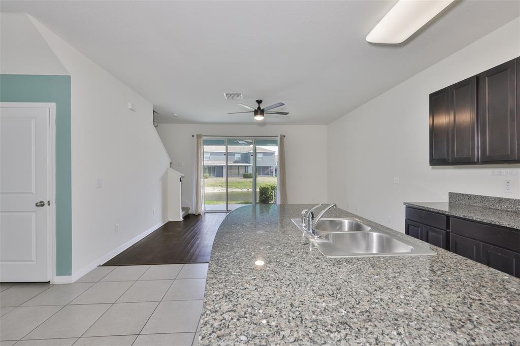 8969 Indigo Trail Loop Riverview, FL 33578 - Photo 8 of 41 a kitchen with granite countertop a sink a stove and cabinets