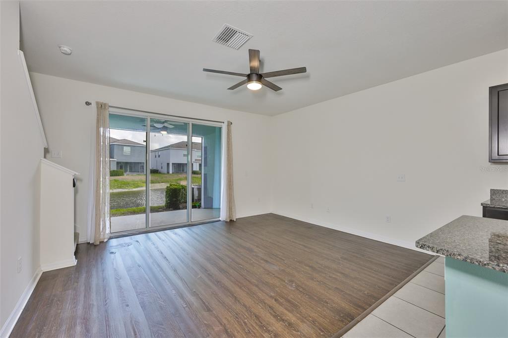 8969 Indigo Trail Loop Riverview, FL 33578 - Photo 9 of 41 an empty room with wooden floor and windows