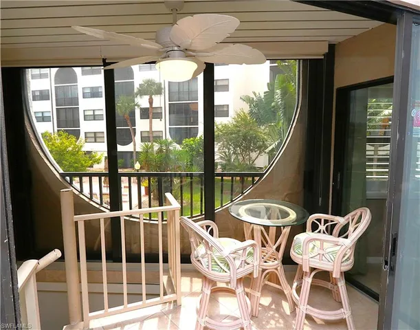 a view of a chairs and table in the balcony