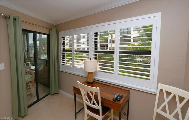 a dining room with furniture and windows