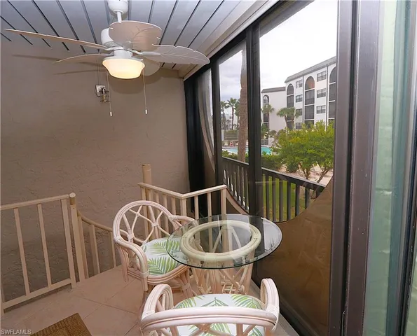 a view of a balcony dining table and chairs