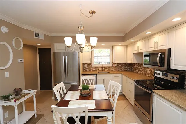 a kitchen with a dining table and chairs