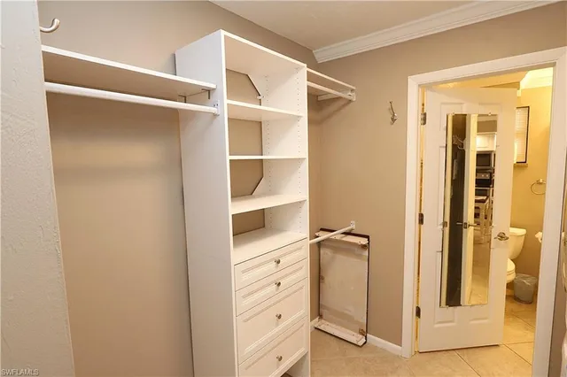 a view of walk in closet with empty racks