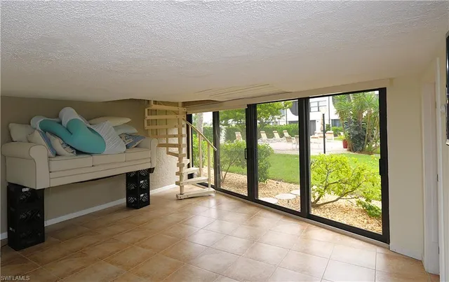 a living room with furniture and large windows