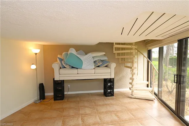 a view of an empty room with a fireplace and a window