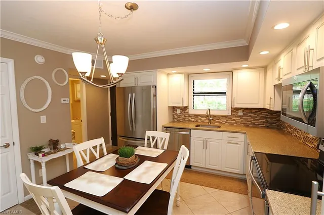 a kitchen with a dining table and chairs