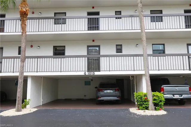 a view of swimming pool with outdoor seating and house in the background