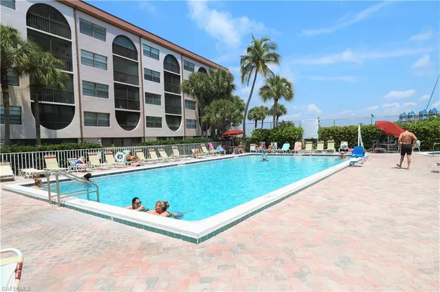a view of swimming pool with outdoor seating