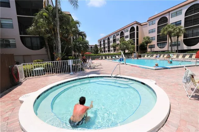 a view of swimming pool with a table and chairs