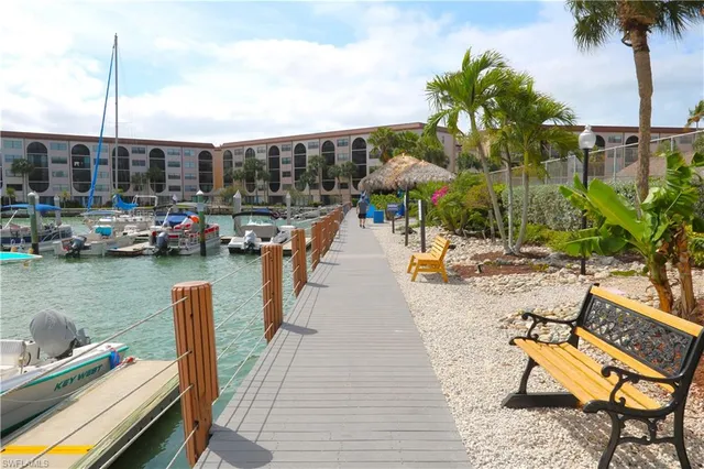 a backyard of a house with yard table and chairs