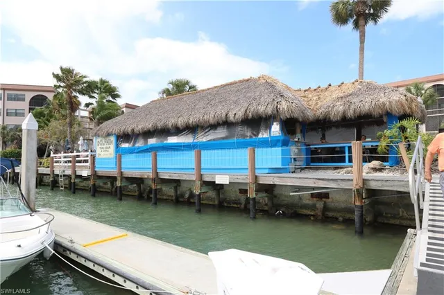 a view of roof deck with table and chairs
