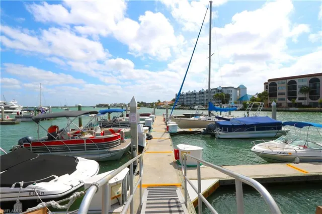 a view of a lake with couches chairs and city view