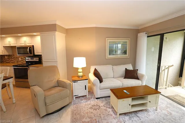 a living room with furniture and a lamp