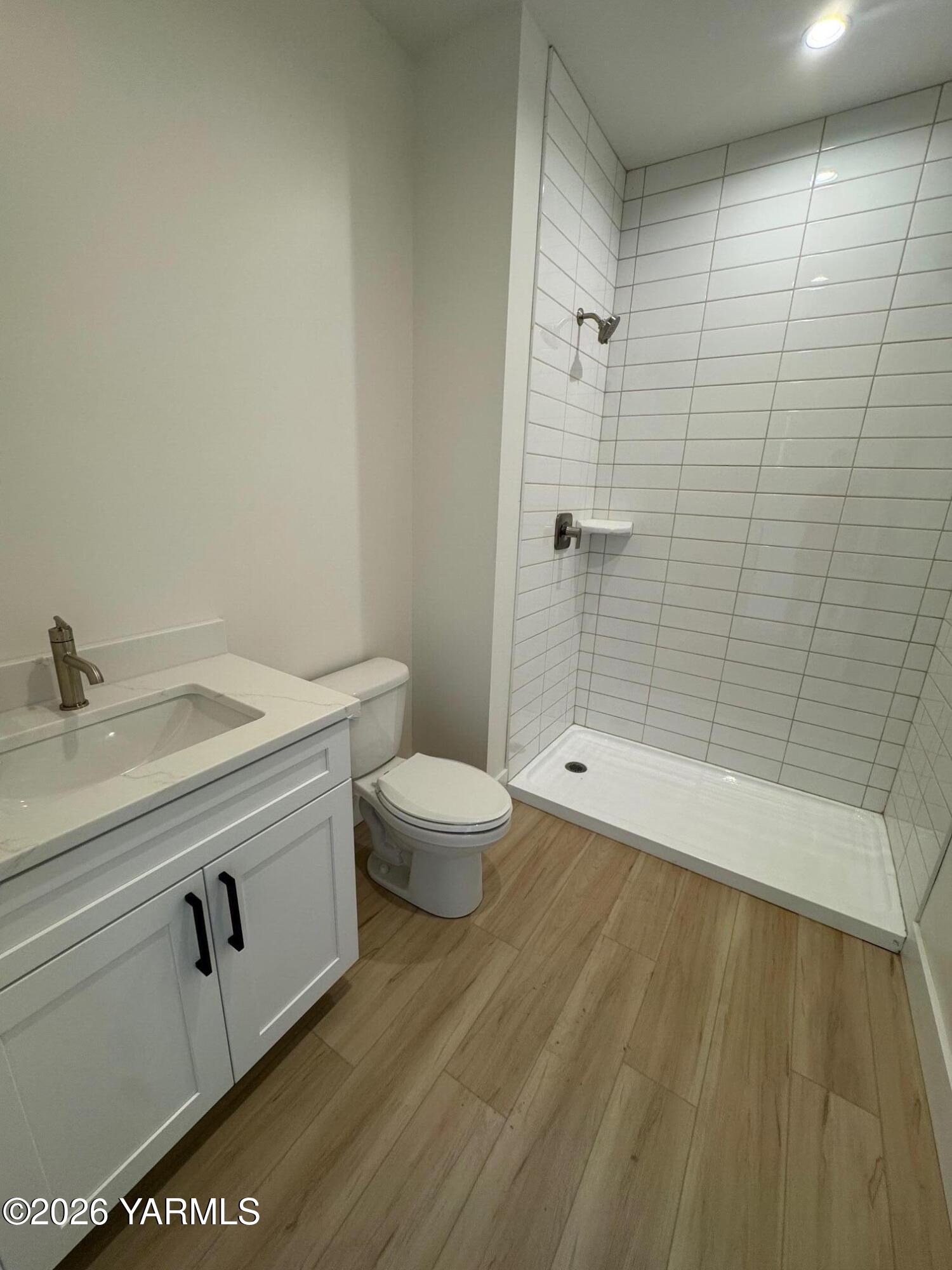 304 6th Street Zillah, WA 98953 - Photo 23 of 29 a bathroom with a granite countertop sink toilet and shower
