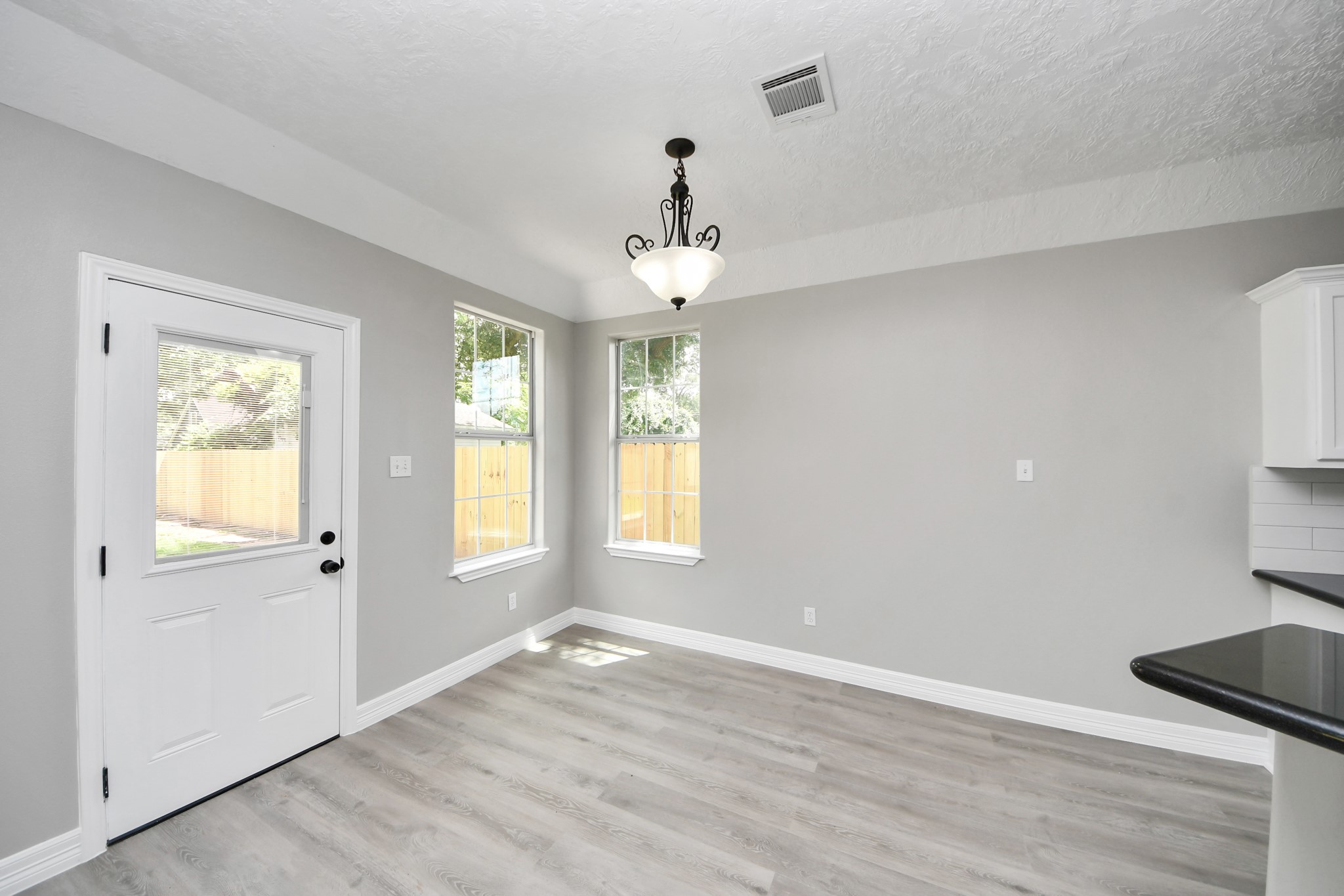 1105 East Kyle Road Clute, TX 77531 - Photo 8 of 44 The dining area features two large windows and a door leading to the backyard, offering ample natural light.