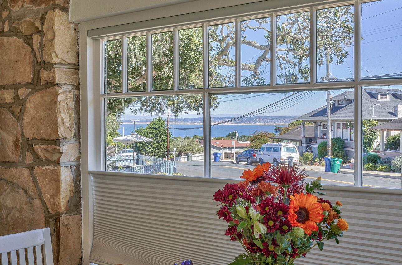 324 Eardley Avenue Pacific Grove, CA 93950 - Photo 17 of 29 a dining room filled with furniture and a potted plant