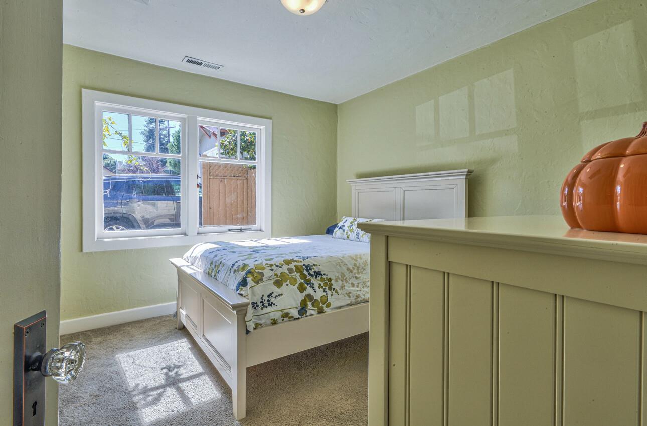 324 Eardley Avenue Pacific Grove, CA 93950 - Photo 19 of 29 a bedroom with a bed and window