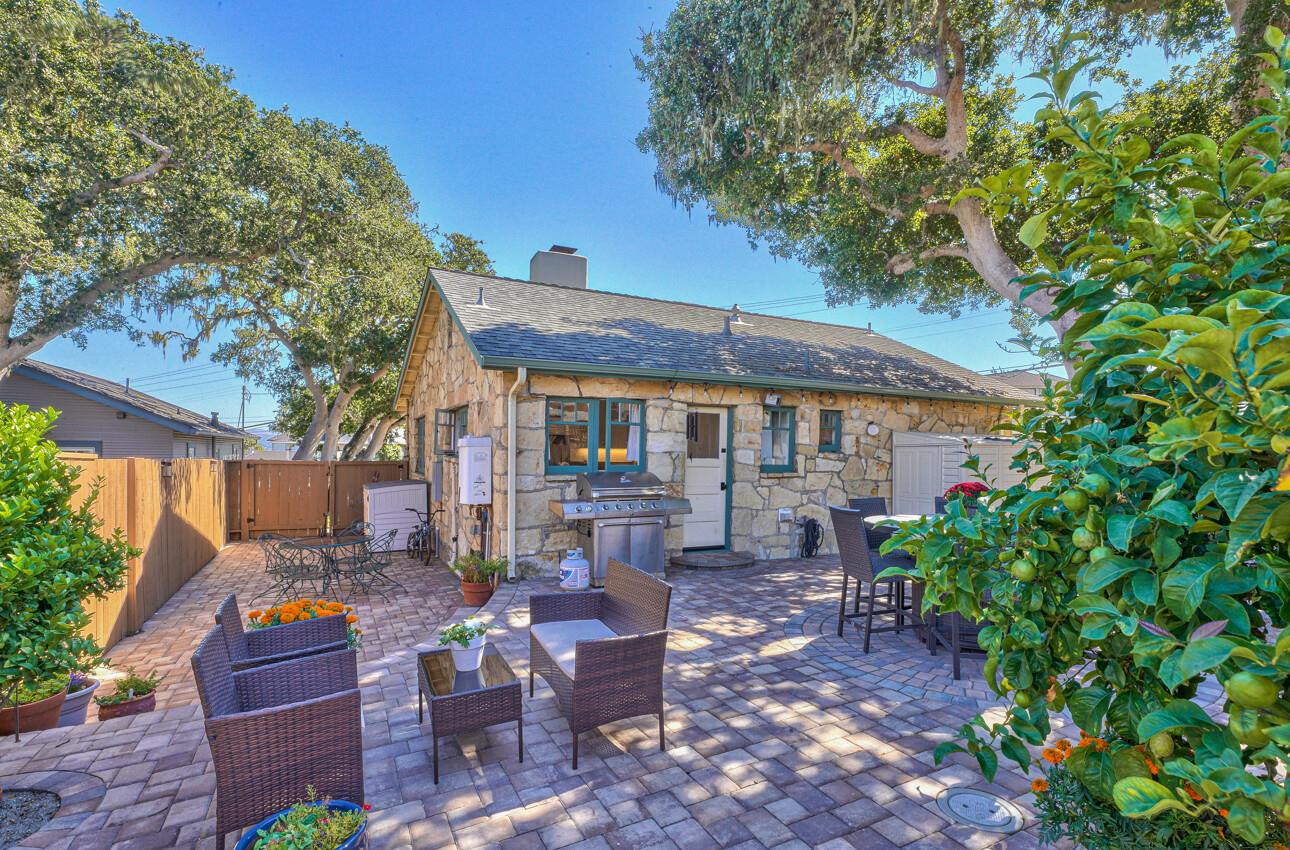 324 Eardley Avenue Pacific Grove, CA 93950 - Photo 26 of 29 a view of a patio with table and chairs potted plants with wooden fence